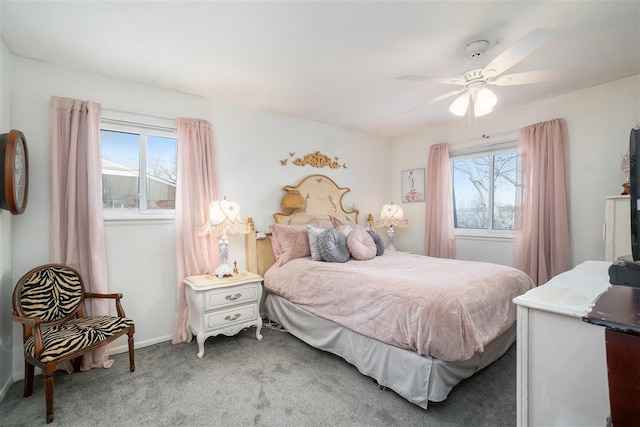 bedroom featuring multiple windows, baseboards, carpet, and ceiling fan