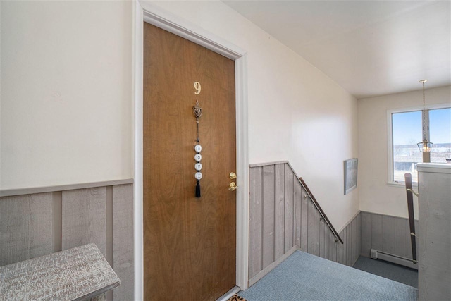 entrance to property featuring a baseboard heating unit