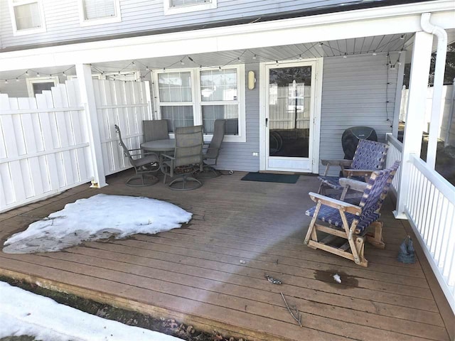 wooden terrace featuring outdoor dining space and fence