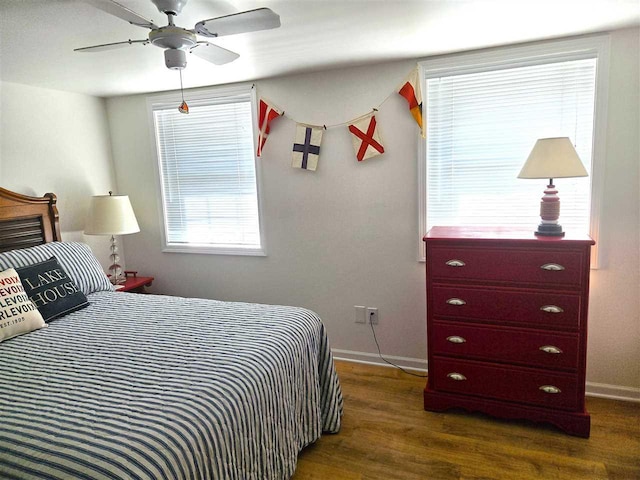 bedroom featuring dark wood-type flooring, a ceiling fan, and baseboards