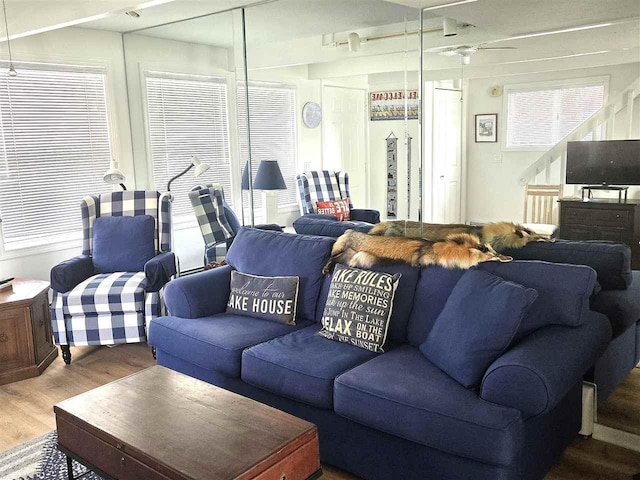 living area featuring wood finished floors and a ceiling fan