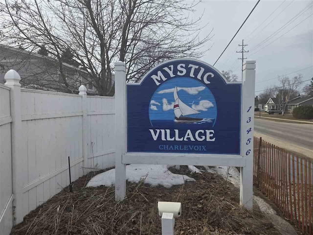 community sign featuring fence