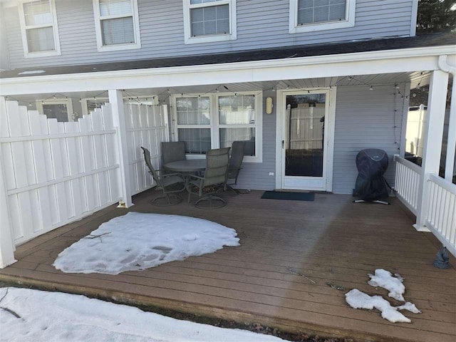 wooden terrace featuring fence