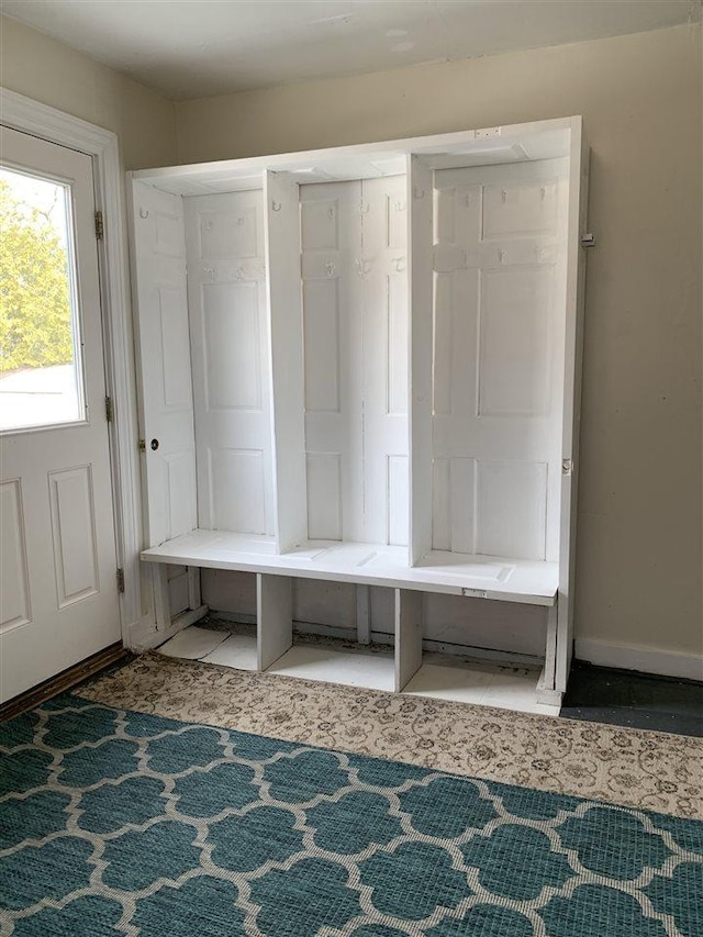 mudroom with tile patterned floors and baseboards