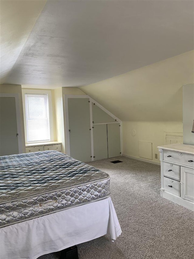 carpeted bedroom featuring vaulted ceiling