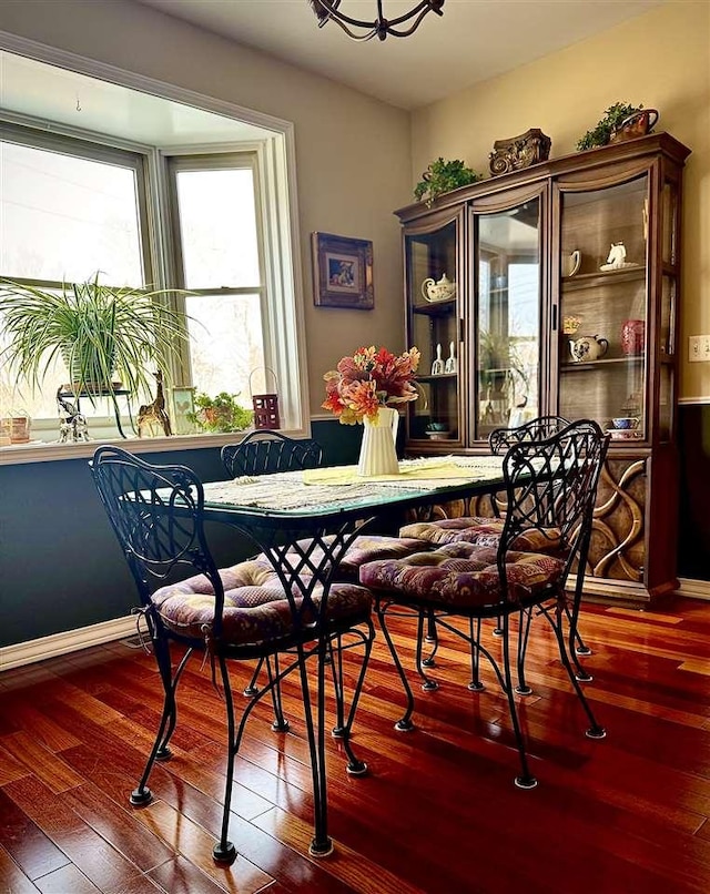 dining room with hardwood / wood-style flooring and baseboards