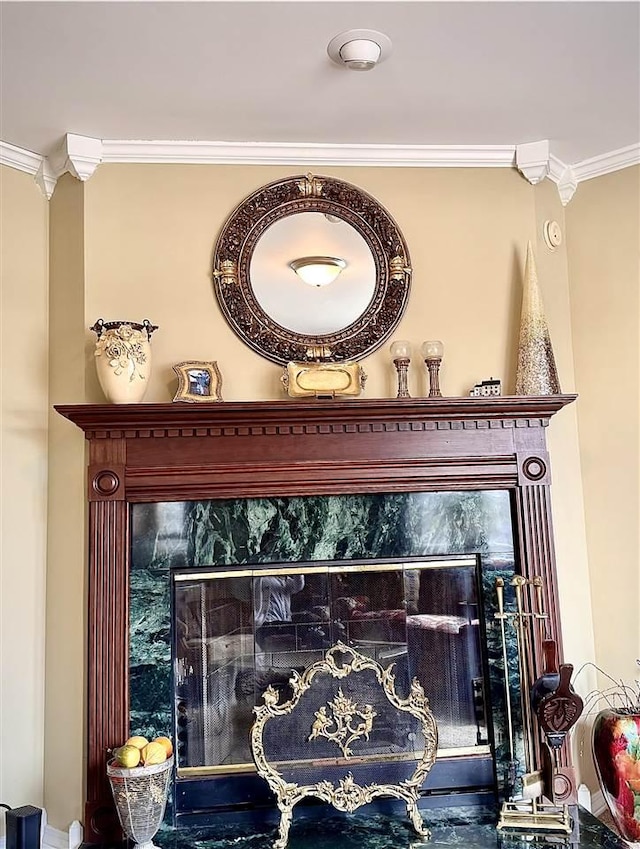 interior details with a fireplace and crown molding