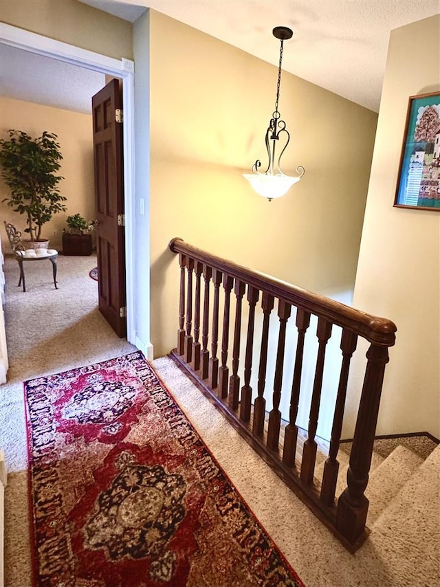 stairs featuring lofted ceiling and carpet