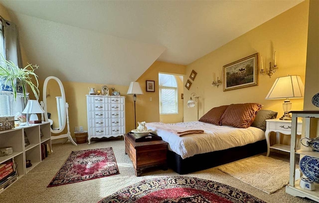 bedroom with carpet floors and lofted ceiling