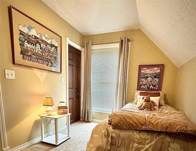 carpeted bedroom with baseboards, a textured ceiling, and vaulted ceiling