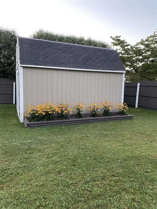 view of shed featuring fence