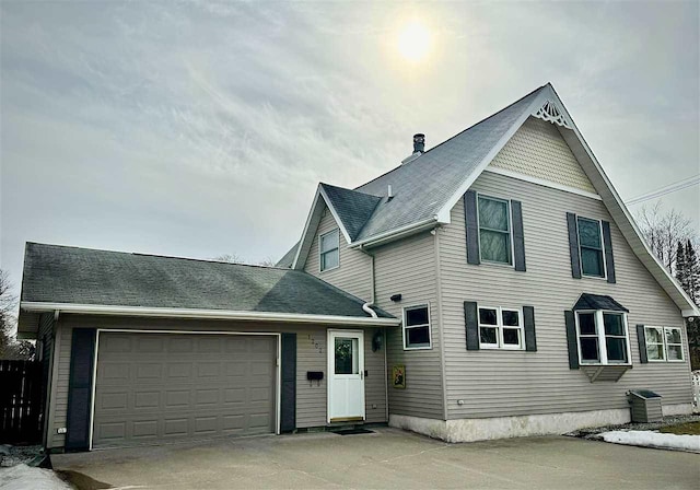 view of front of home with concrete driveway and a garage