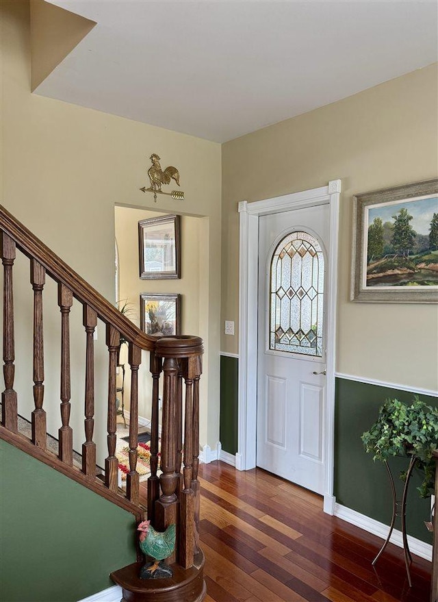 foyer with stairway, baseboards, and dark wood-style flooring