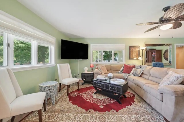living area with ceiling fan and plenty of natural light