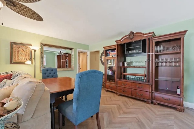 dining area with ceiling fan and baseboards