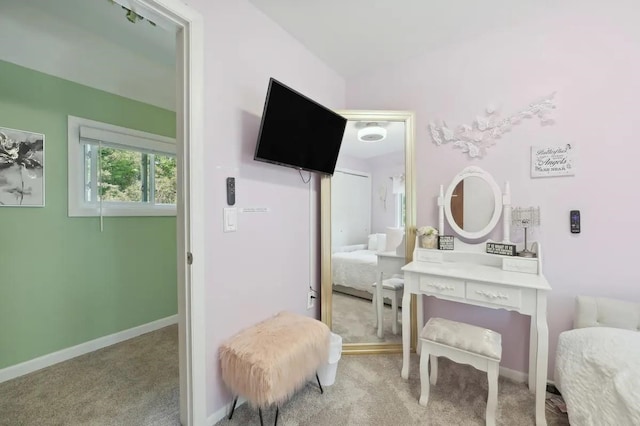 ensuite bathroom featuring ensuite bath and baseboards
