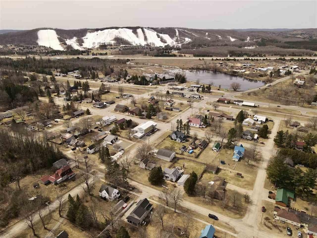 drone / aerial view with a water and mountain view