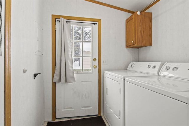 7116 S M-88 Hwy, Bellaire, MI 49615 - laundry area featuring cabinet space, ornamental molding, and washer and dryer