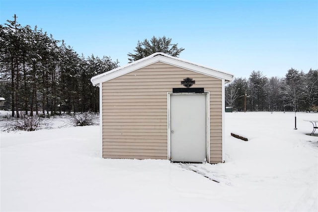 7116 S M-88 Hwy, Bellaire, MI 49615 - snow covered structure with an outbuilding and a storage unit