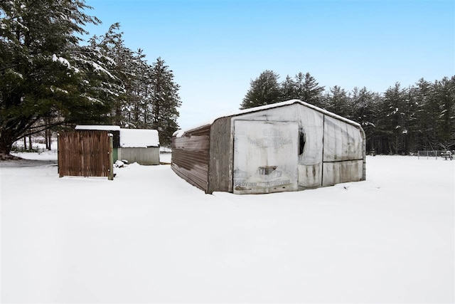 7116 S M-88 Hwy, Bellaire, MI 49615 - snow covered structure with a storage unit and an outdoor structure