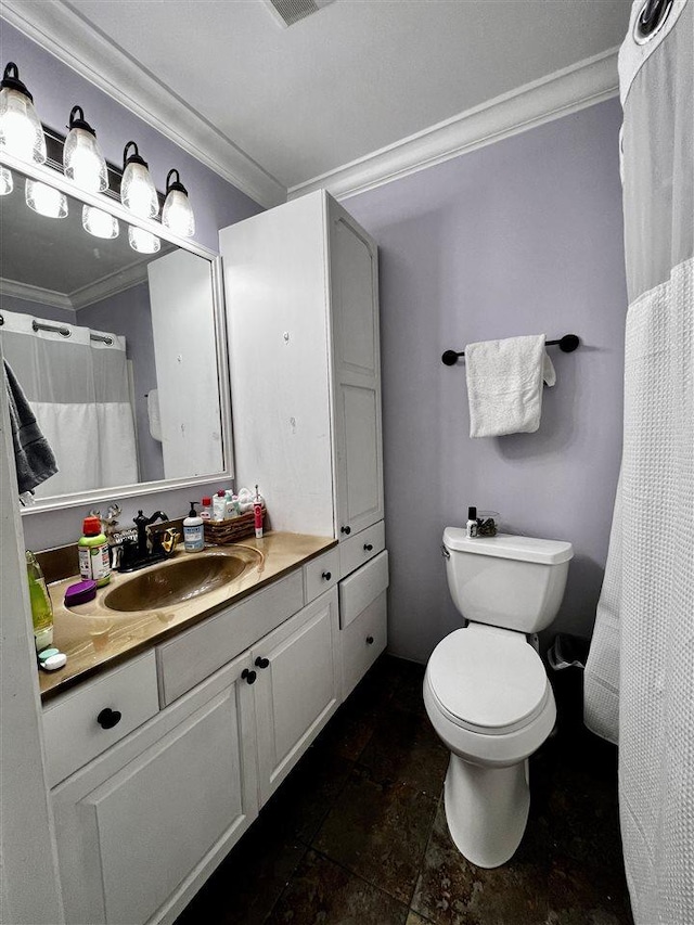 bathroom with toilet, vanity, and ornamental molding