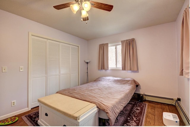 2382 Pleasant Valley Rd, Boyne City, MI 49712 - bedroom featuring dark wood-type flooring, a closet, baseboards, and a ceiling fan