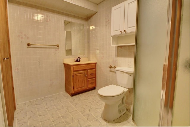 2382 Pleasant Valley Rd, Boyne City, MI 49712 - bathroom featuring toilet, tile walls, and vanity