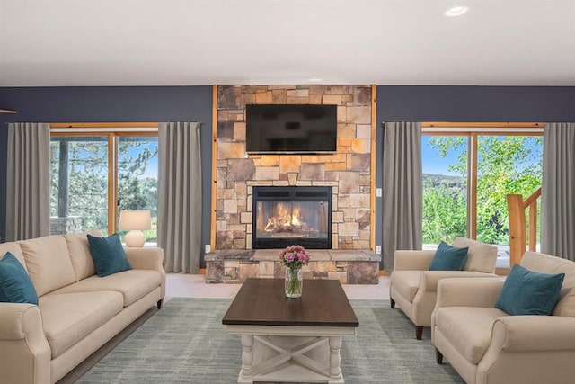 988 Ridgeline Dr, Boyne City, MI 49712 - carpeted living room with a stone fireplace and a healthy amount of sunlight