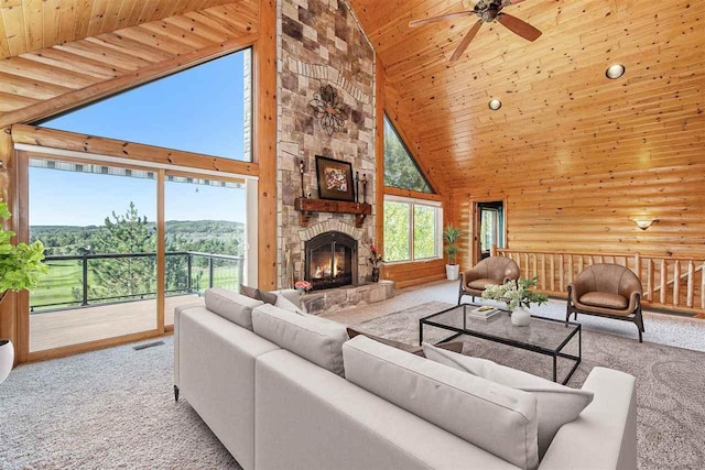 988 Ridgeline Dr, Boyne City, MI 49712 - carpeted living room featuring visible vents, wooden ceiling, ceiling fan, a fireplace, and lofted ceiling