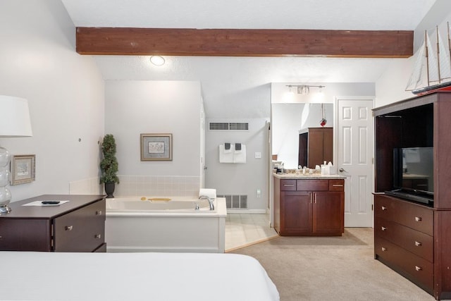 bathroom with a garden tub, vanity, visible vents, and beamed ceiling