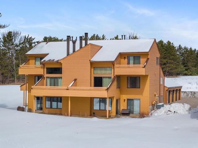 view of snow covered rear of property