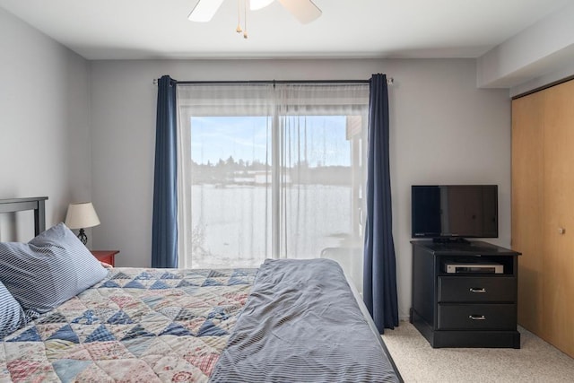 bedroom with a ceiling fan and light carpet