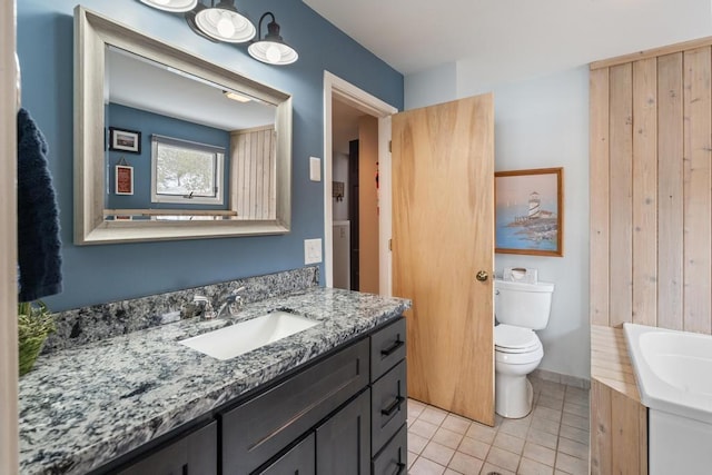 full bath with tile patterned flooring, vanity, and toilet