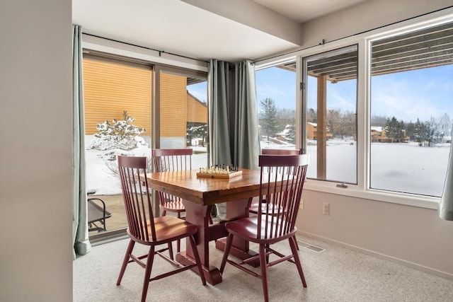 dining space featuring baseboards
