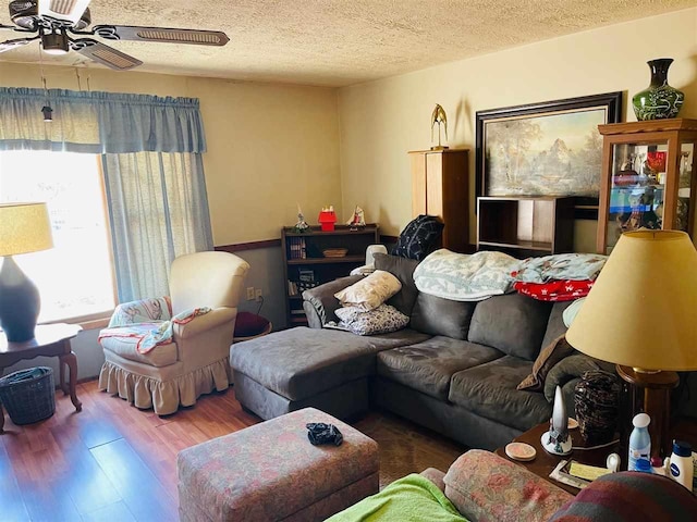 4635 Mohrmann Rd, Central Lake, MI 49622 - living room featuring a textured ceiling, wood finished floors, and ceiling fan