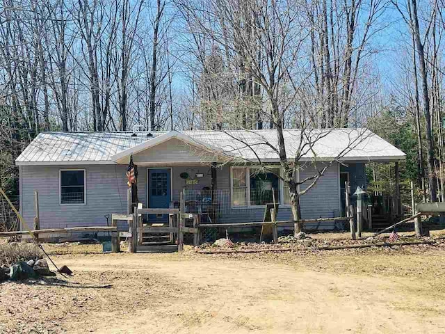 4635 Mohrmann Rd, Central Lake, MI 49622 - single story home featuring a porch and metal roof