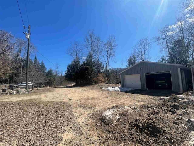 4635 Mohrmann Rd, Central Lake, MI 49622 - view of yard featuring a garage and an outbuilding