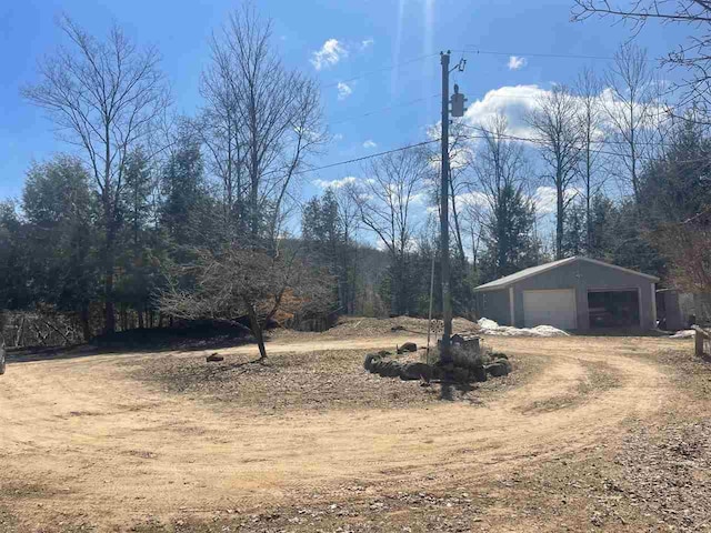 4635 Mohrmann Rd, Central Lake, MI 49622 - view of yard featuring a detached garage, an outdoor structure, and driveway