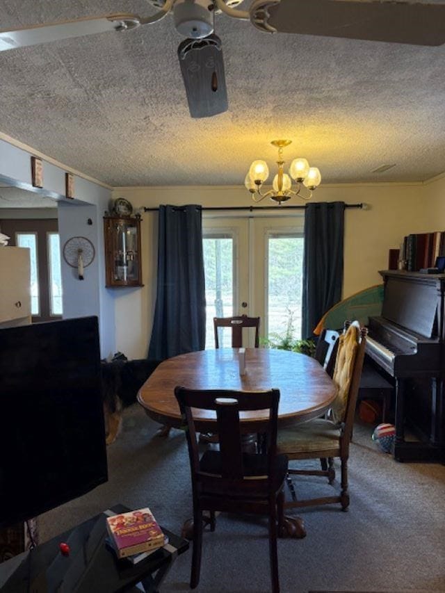 4462 E Brutus Rd, Alanson, MI 49706 - dining room with carpet, a textured ceiling, and an inviting chandelier