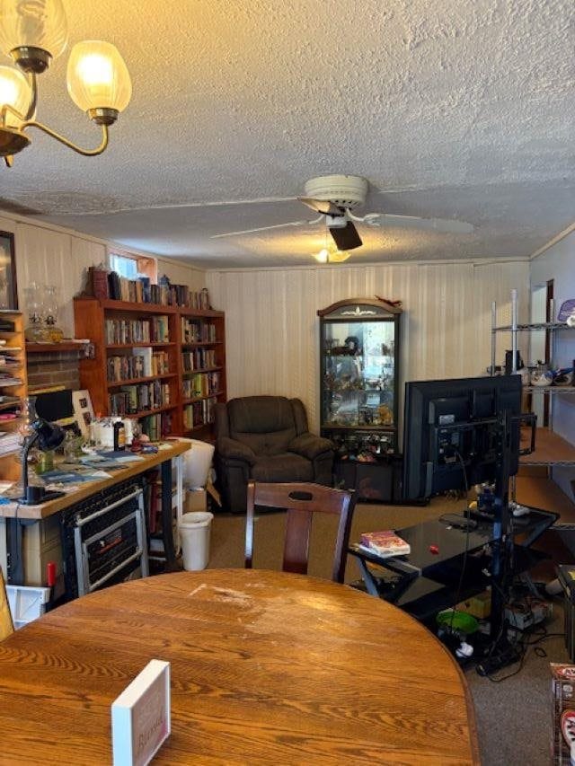 4462 E Brutus Rd, Alanson, MI 49706 - carpeted dining area with ceiling fan with notable chandelier, beverage cooler, and a textured ceiling