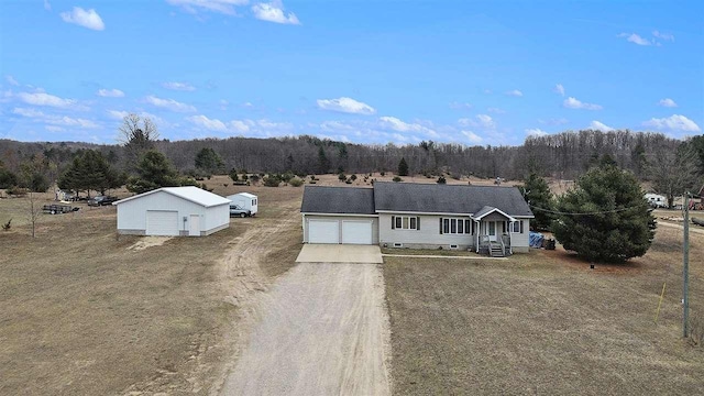 9196 NW Manley Rd, Alden, MI 49612 - ranch-style house featuring a wooded view and driveway