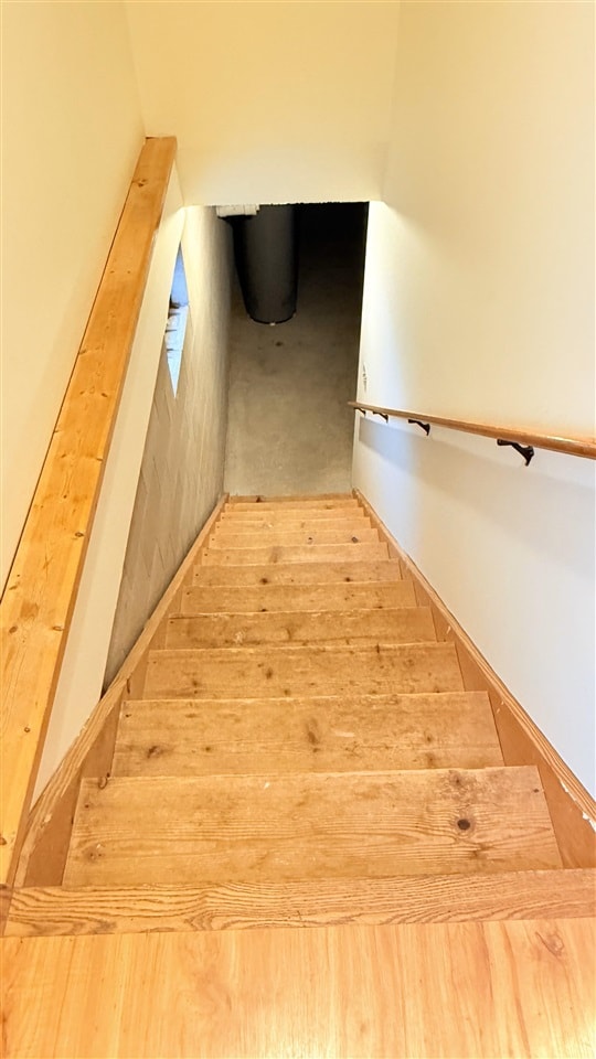 9196 NW Manley Rd, Alden, MI 49612 - stairway featuring baseboards and wood finished floors
