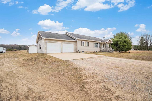 9196 NW Manley Rd, Alden, MI 49612 - ranch-style home featuring a front yard, a storage shed, an attached garage, an outbuilding, and driveway