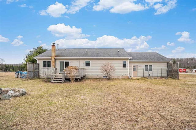 9196 NW Manley Rd, Alden, MI 49612 - back of house featuring a deck, a chimney, and a lawn