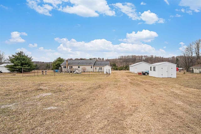 9196 NW Manley Rd, Alden, MI 49612 - view of yard with an outbuilding and fence