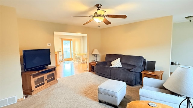 9196 NW Manley Rd, Alden, MI 49612 - living area featuring ceiling fan, baseboards, carpet flooring, and visible vents