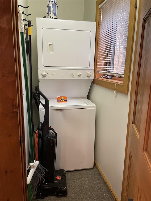 laundry area featuring stacked washer and clothes dryer and laundry area