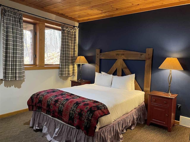 carpeted bedroom with baseboards, wooden ceiling, and visible vents