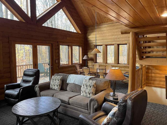 carpeted living area featuring wooden ceiling, wood walls, and plenty of natural light