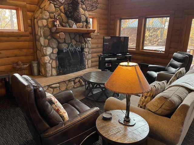 living room with a wealth of natural light, log walls, and a fireplace